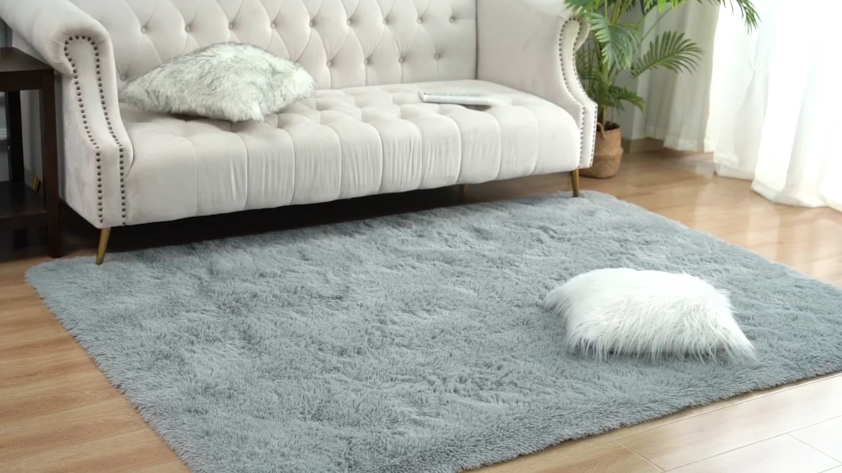 A sage LOCHAS shag rug in a living room, pile lit from the window